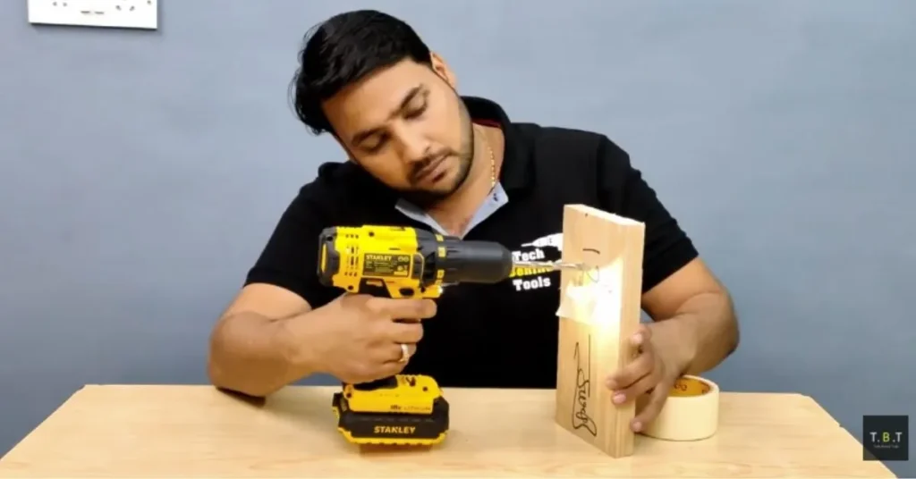 Masking tape dust catcher used while drilling into a wall.