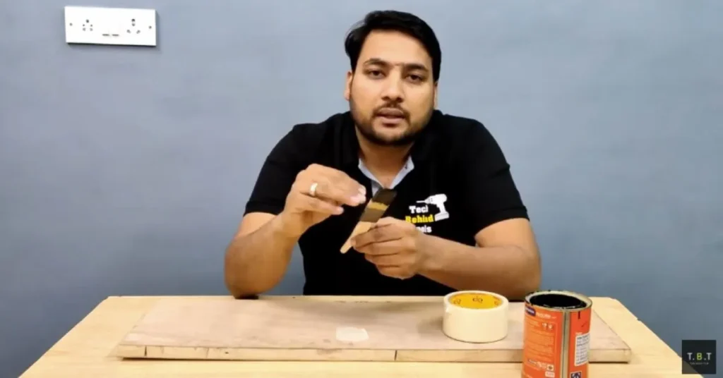 Paint brush protected with masking tape to maintain bristle shape