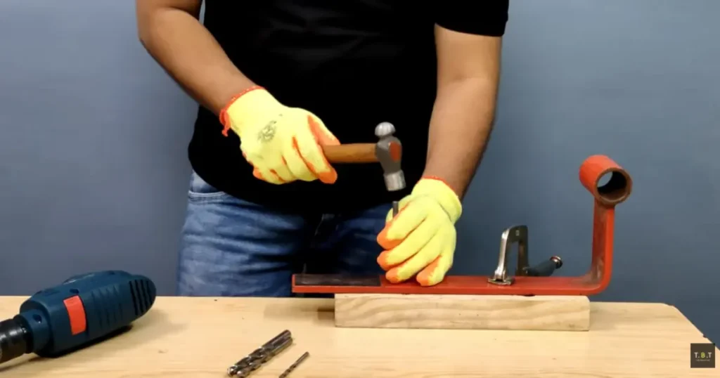 Creating a center punch mark before drilling metal
