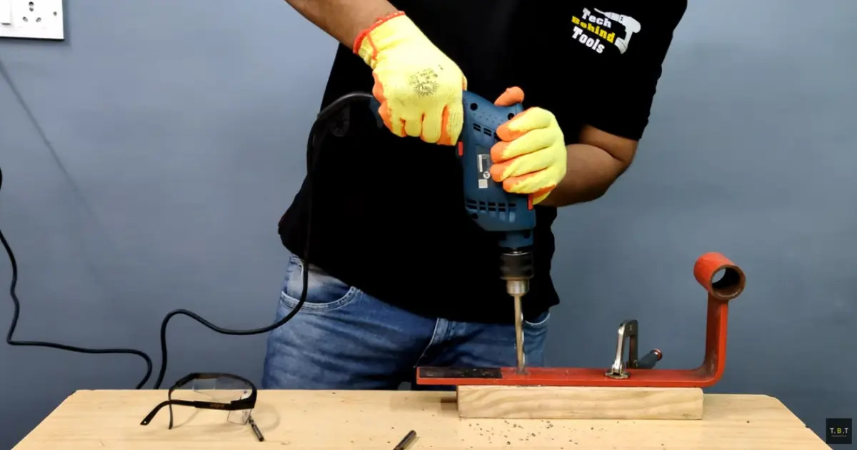 HSS drill bit drilling through steel plate with metal chips